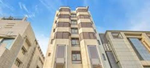 a tall building with windows on top of it at PPH Living Railotel Coimbatore in Coimbatore