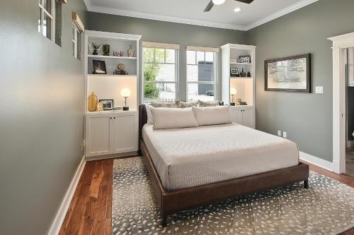 a bedroom with a bed and a window at Luxury 5 BR 4 Bath, Hot Tub, Outdoor Kitchen, Across Street from Kyle Field! in College Station