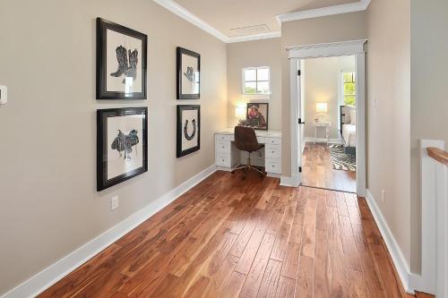 a home office with a desk and pictures on the wall at Luxury 5 BR 4 Bath, Hot Tub, Outdoor Kitchen, Across Street from Kyle Field! in College Station
