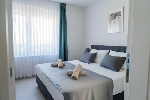 a bedroom with a bed with two towels on it at Villa Full Moon Luxury Apartments Novalja in Novalja
