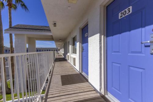 a walkway to a house with a blue door at Motel 6-Phoenix, AZ - Airport - 24th Street in Phoenix