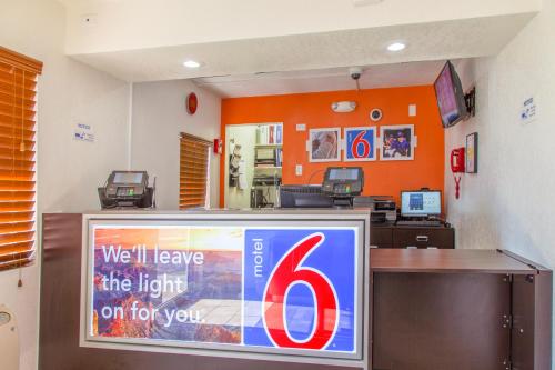 a room with a television, refrigerator, and other items on the wall at Motel 6-Phoenix, AZ - Airport - 24th Street in Phoenix