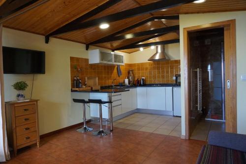 a kitchen with a counter and a sink in it at Ocean View Cottage in Ponta do Pargo