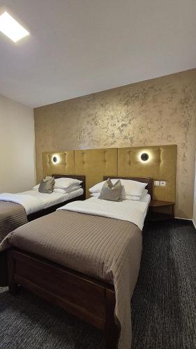 a hotel room with two beds in a room at Penzion Nevada in Dunajská Streda