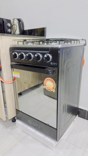 a oven with its door open in a kitchen at SN suites apartment in Bulambiro