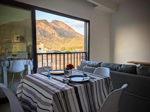 a dining room table with a view of a mountain at Tarrafal Bay - 1Bdr Apt - Sea view -1 in Tarrafal