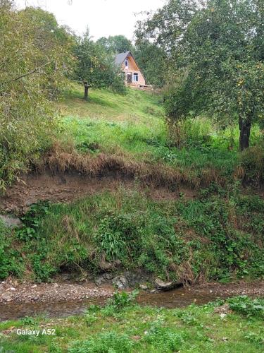 a house on top of a hill with a field at Aframe Əsrikçay in Slavyanka