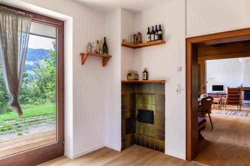 a living room with a fireplace and a sliding glass door at Ferienhaus Birnberg in Leogang