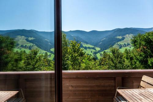 a view of the mountains from the balcony of a house at Ferienhaus Birnberg in Leogang