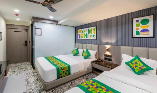 a hotel room with two beds and a corridor at Treebo KBC in Ahmedabad