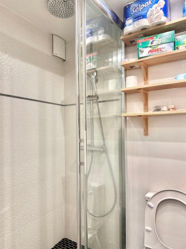 une douche dans une salle de bain avec toilettes dans l'établissement Cozy Apartment Near Marais on Rue Trousseau, à Paris