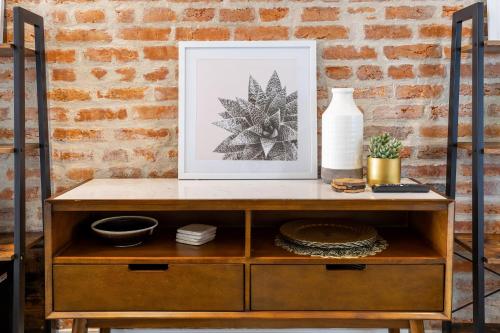 a picture on top of a wooden cabinet with a picture on top at Charming 2BR Townhouse with Patio & Parking in DC in Washington