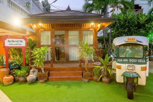 a small house with a scooter parked in front of it at Hua Hin Golf Villa in Hua Hin