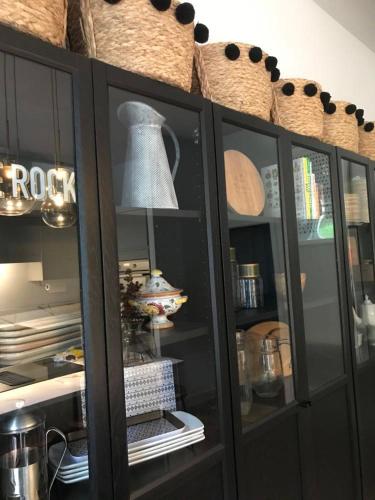a black cabinet with a bell on top of it at Historic manoir in Vire Normandy elegance in a semi-rural setting ideal for groups and families in Vire