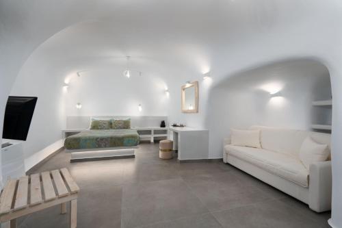 a white living room with a couch and a bed at NEW Yiota Collection 4 Suites & 4 Prive Jacuzzi in Megalokhori