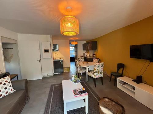 a living room with a couch and a table at Appartement Remparts de Guérande in Guérande