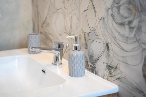 a bathroom with a soap dispenser on a sink at Freedom in SantʼAntonio Abate