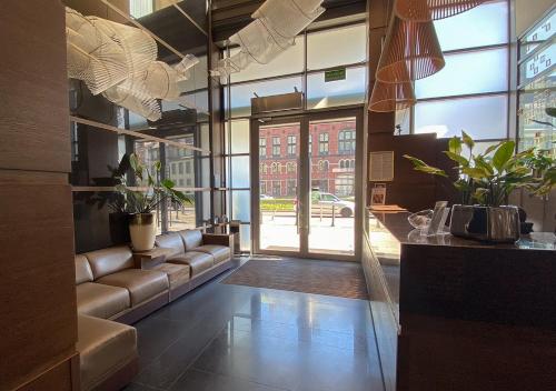 a living room with a couch and a large window at Europeum Hotel in Wrocław