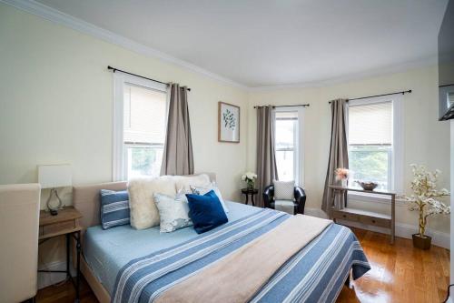 a bedroom with a large bed with blue pillows at 14b-Newly Renovated, Uniquely decorated Apartment in Boston