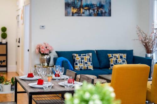 a living room with a table and a blue couch at 14b-Newly Renovated, Uniquely decorated Apartment in Boston