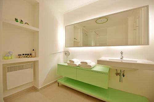 a bathroom with a sink and a mirror at Hydra Kamini Beach Thea in Hydra