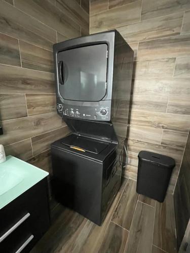 a television sitting on top of a stand in a room at Villa Carmin I - Apartment with Private Pool in Aguadilla