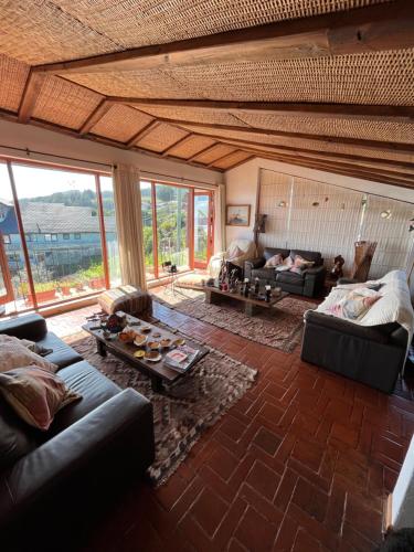 a living room with a couch and a table at Curanipe Sea View in Curanipe