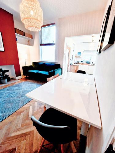 a living room with a white table and a couch at Upscale Family Home Beautiful Setting in Woolton