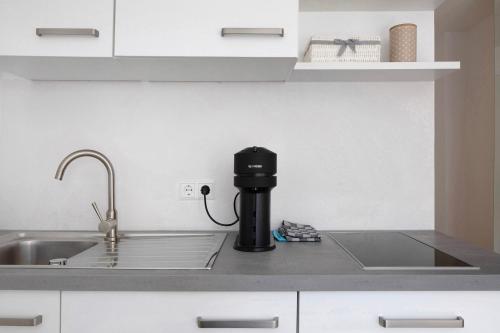 a coffee machine sitting on a counter in a kitchen at Ferienwohnung Romeo, sehr zentral in Freiburg im Breisgau