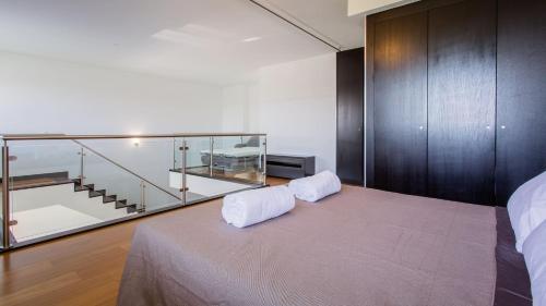 ein Schlafzimmer mit einem Bett mit Glaskasten darauf in der Unterkunft Monte Laguna Duplex - Greice Homes in Estibeira