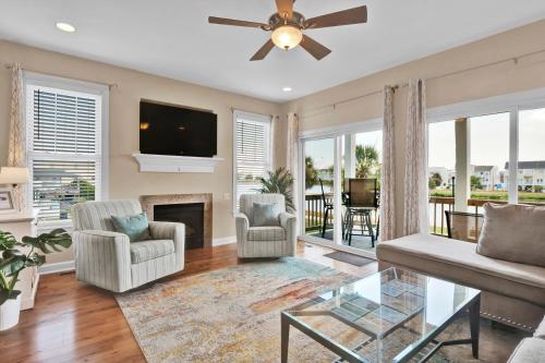 a living room with a fireplace and a flat screen tv at Pelican Pleasure by Sea Scape Properties in Carolina Beach