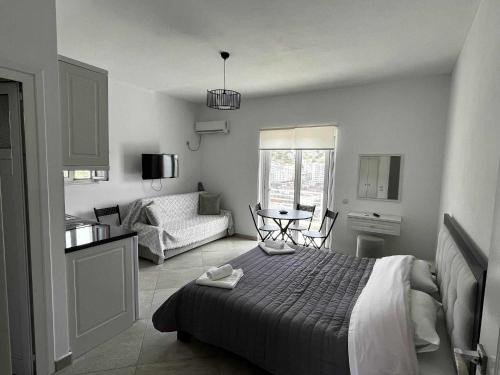 a bedroom with a bed and a living room at Mariana Apartments in Sarandë