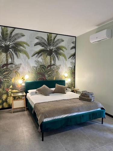 a bedroom with a bed with a mural of palm trees at Golden Palm B&B in Bari