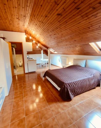 a bedroom with a large bed with a wooden ceiling at CASTAGNETO 8 in Rapallo