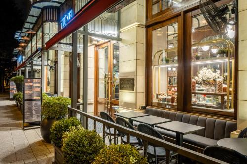 a restaurant with tables and chairs in front of a store at Hotel Momento Golden Horn in Istanbul