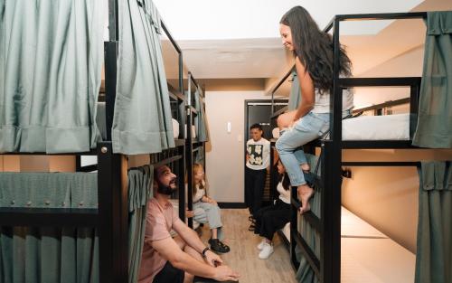 a group of people in a room with bunk beds at Mad Monkey Manila in Manila