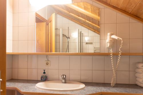 a bathroom with a sink and a mirror at NigschHof in Schoppernau