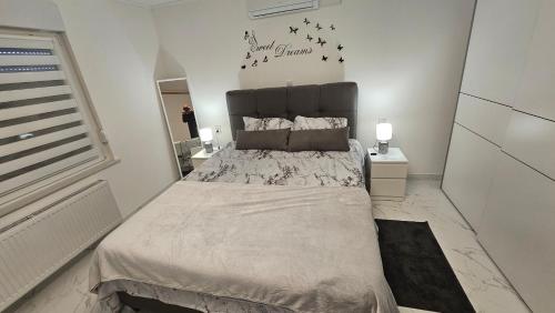 a bedroom with a large bed with birds on the wall at ENA 1&2 -BIG FREE PRIVAT parking for BOATS, TRUCKs, combi,-CENTRAL HEATING !!! in Karlovac