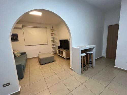 a living room with an arch with a couch and a table at Ocean View Rooftop, Casa Estela Mar, Isabela, Cozy, Boutique in Isabela