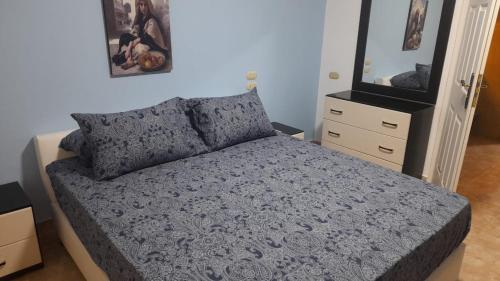 a bedroom with a bed and a dresser at Delta Sharm luxury pool view apartment Shahrazad in Sharm El Sheikh