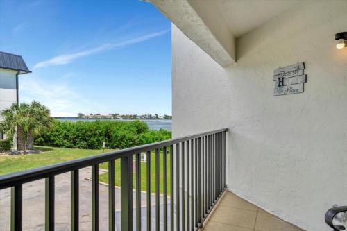 a balcony with a view of the water at Cheerful Oasis on Anna Maria Island in Bradenton Beach