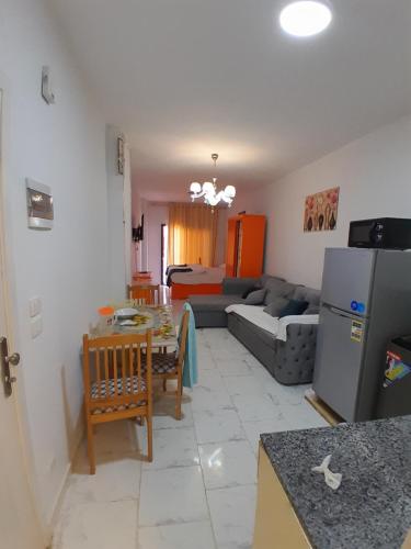 une cuisine et un salon avec un canapé et une table dans l'établissement Turtles Beach resort hourghada Studio view sea view pool private beach jacuzzi pools air-conditioned restaurant on the beach jacuzzi security and a large sunny balcony, à Hurghada