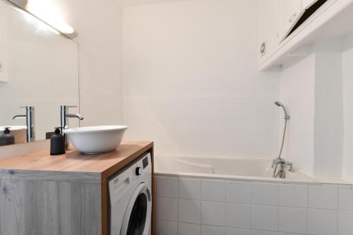 une cuisine avec un évier et une machine à laver dans l'établissement Superbe appartement à 10 min du Vieux Port, à Marseille