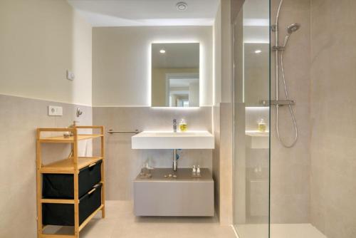 a bathroom with a sink and a shower at Luxury Penthouse with Panoramic Sea Views in Canet de Berenguer