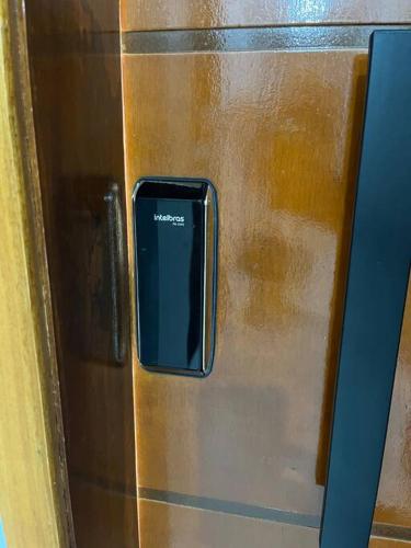 a metal refrigerator with a cell phone on it at Apt próximo do metrô carrão in Sao Paulo