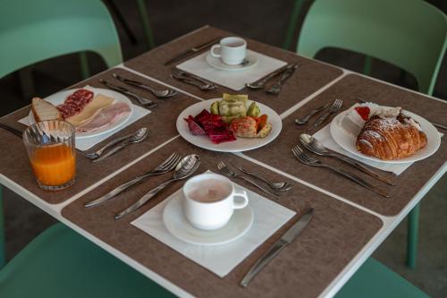 a table with plates of food and a cup of coffee at Manfredomus in Mussomeli