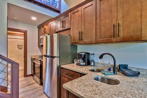 a kitchen with wooden cabinets and a stainless steel refrigerator at Retreat on the Lake in Hiawassee