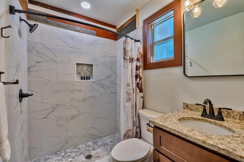 a bathroom with a shower and a toilet and a sink at Retreat on the Lake in Hiawassee