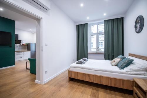 Postel nebo postele na pokoji v ubytování Apartament Łokietka