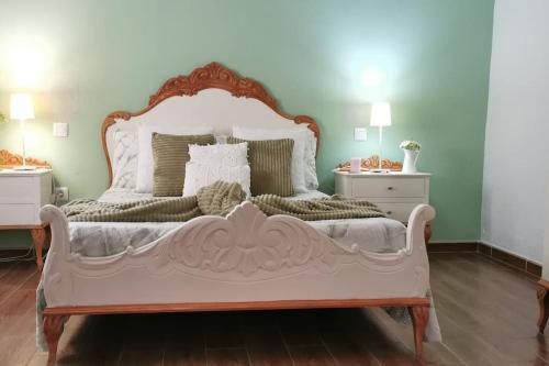 a bedroom with a large white bed with two night stands at La Casita de Coco Tejeda in Tejeda